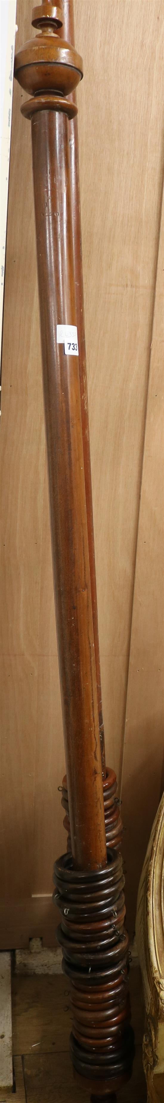 A mahogany curtain pole and a stained pine curtain pole